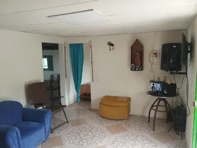 a living room with a blue couch and a tv at Casa finca en pueblo rico Neira in Neira