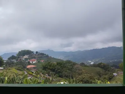 a view of a town on a hill with mountains at Casa finca en pueblo rico Neira in Neira