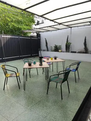 a patio with two tables and two chairs at Urban Oasis Med in Medellín