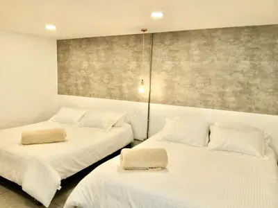 two beds sitting next to each other in a room at Urban Oasis Med in Medellín