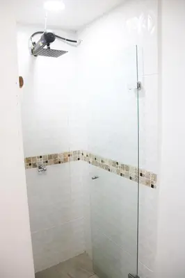 a shower with glass doors in a bathroom at Urban Oasis Med in Medellín