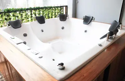 a white bath tub sitting in a bathroom at Urban Oasis Med in Medellín