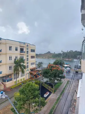 a view of a building and a river at Hotel Los Colores GUATAPE in Guatapé