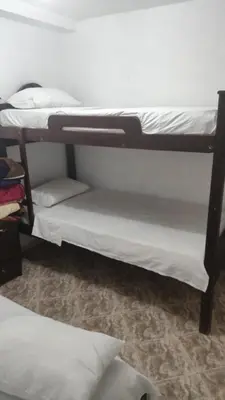a couple of bunk beds in a room at Hotel Los Colores GUATAPE in Guatapé