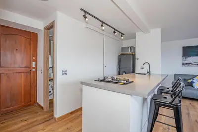 a kitchen with a counter top and a stove at Torre Pravia By Host Medellin in Medellín