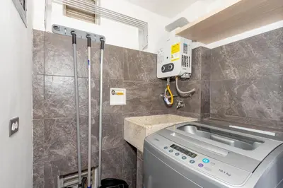 a washing machine in a bathroom with a sink at Torre Pravia By Host Medellin in Medellín