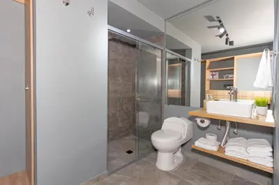 a bathroom with a toilet and a shower and a sink at Torre Pravia By Host Medellin in Medellín