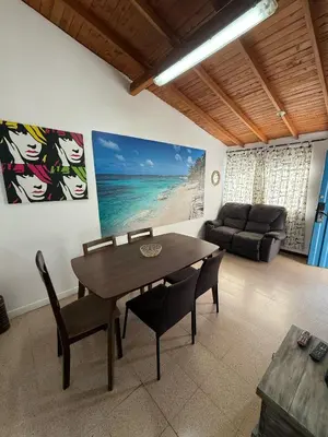 a dining room with a table and chairs and a couch at Apartamento Sosiego in Medellín