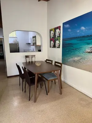 a dining room with a wooden table and chairs at Apartamento Sosiego in Medellín