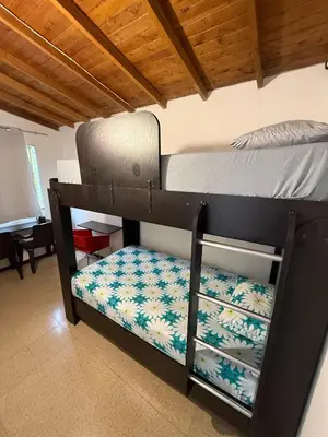 two bunk beds in a room with a bed at Apartamento Sosiego in Medellín