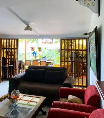 a living room with a couch and a table at Hotel Campestre Alto lindo en Guatapé in Guatapé