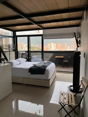 a bedroom with a bed and a view of a city at Suite ps8 in Medellín