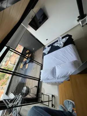 a room with two beds and a large window at Suite ps8 in Medellín