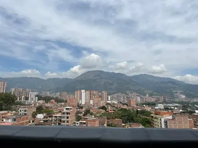 a view of a city with buildings and mountains at Suite ps8 in Medellín