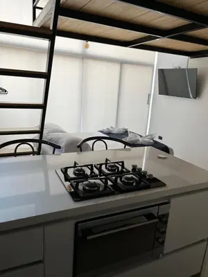 a kitchen with a stove top oven in a room at Suite ps8 in Medellín