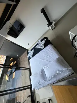 a bed in a room with a window at Suite ps8 in Medellín