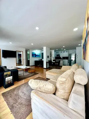 a large living room with a couch and a table at Hermoso apartamento en El Poblado in Medellín