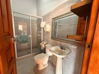 a bathroom with a toilet and a sink and a shower at Paradise San Jeronimo Parcelacion 6BR AC Pool in San Jerónimo