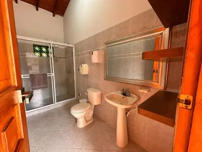 a bathroom with a toilet and a sink at Paradise San Jeronimo Parcelacion 6BR AC Pool in San Jerónimo