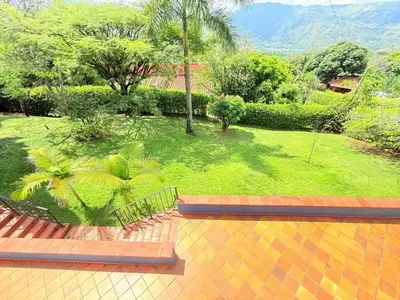 a view of a garden with a bench on a patio at Paradise San Jeronimo Parcelacion 6BR AC Pool in San Jerónimo