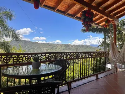 a patio with a table and chairs on a balcony at Paradise San Jeronimo Parcelacion 6BR AC Pool in San Jerónimo