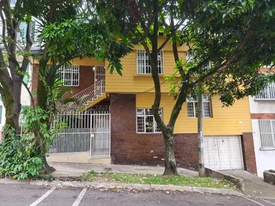 a yellow building with a staircase on the side of it at Casa Prado Centro in Medellín