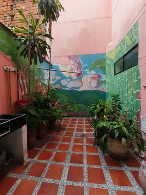 a room with plants and a wall with a mural at Casa Prado Centro in Medellín