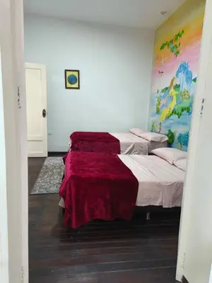 a bedroom with two beds with a red blanket at Casa Prado Centro in Medellín