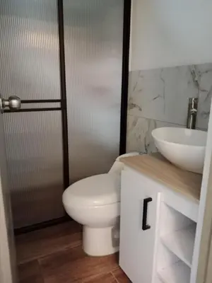 a bathroom with a toilet and a sink at Envigado tradicion y modernidad in Envigado