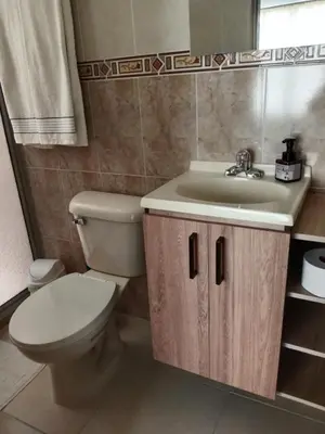 a bathroom with a toilet and a sink at Envigado tradicion y modernidad in Envigado