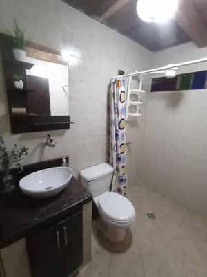 a bathroom with a toilet and a sink at Finca Oriente Antioqueño Guarne Rionegro in Guarne