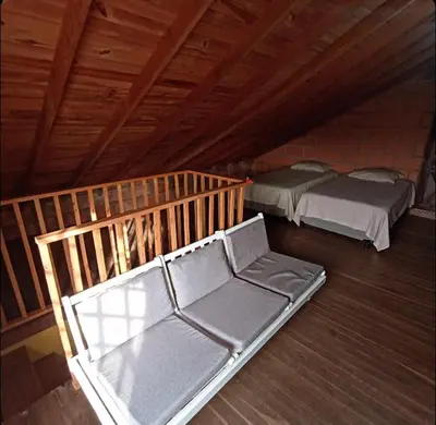 an attic room with two beds and a couch at Finca Oriente Antioqueño Guarne Rionegro in Guarne