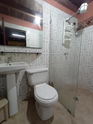a bathroom with a toilet and a sink and a shower at Finca Oriente Antioqueño Guarne Rionegro in Guarne