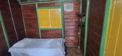 a small room with a bed and a window at Cabaña Los Almendros in Puerto Triunfo