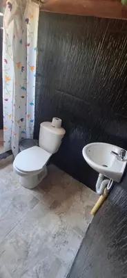 a bathroom with a toilet and a sink at Cabaña Los Almendros in Puerto Triunfo