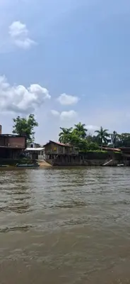 a group of houses on the banks of a river at Cabaña Los Almendros in Puerto Triunfo