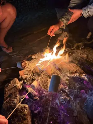 a group of people standing around a campfire at Casa incluyendo Glamping! 13 personas, Familias con niños in Jardin