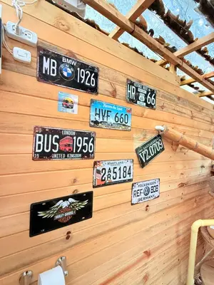 a wall with many signs on a wooden wall at Casa incluyendo Glamping! 13 personas, Familias con niños in Jardin