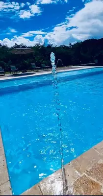 a water fountain in a swimming pool at Luxury Estate with Private Pool & Jacuzzi in Sopetran