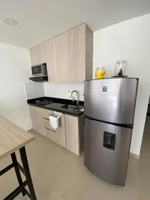 a kitchen with a stainless steel refrigerator and a stove at Acogedor y cómodo apartamento in Sabaneta