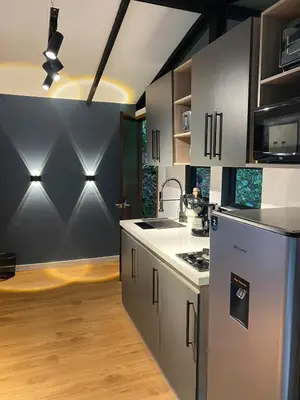 a kitchen with stainless steel appliances in a room at Luxury Cabin in the Forest in El Retiro
