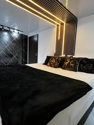 a bedroom with a large bed with a large mirror at Le Jardin d A in Santa Bárbara