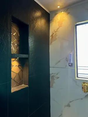a bathroom with a shower with a glass wall at Le Jardin d A in Santa Bárbara