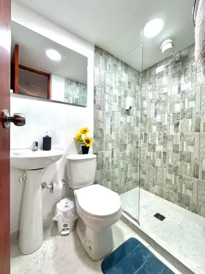 a bathroom with a toilet and a sink and a shower at Alojamiento Central en Medellín en Zona Turística BA in Medellín