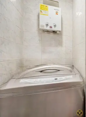 a washer and dryer in a tiled bathroom at Apartamento con aire laureles201 in Medellín