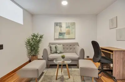 a living room with a couch and a chair at Apartamento con aire laureles201 in Medellín