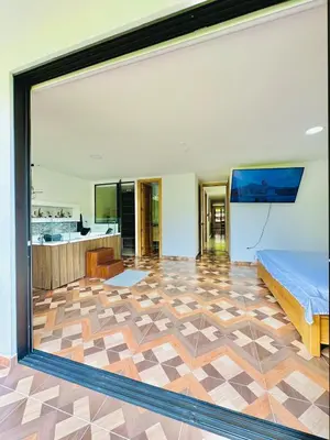 a bedroom with a bed and a large window at La camelia in Jardin