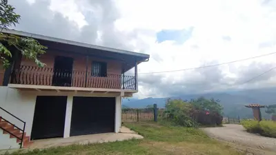 a house with a balcony on the side of it at Cabaña Mirador Santa Ana in San Rafael
