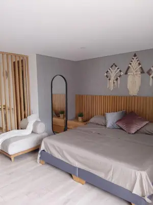 a bedroom with a large bed and a mirror at New Countryside Apartaloft 213 in El Retiro