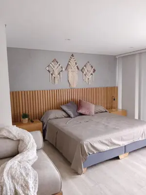a bedroom with a large bed and a chair at New Countryside Apartaloft 213 in El Retiro